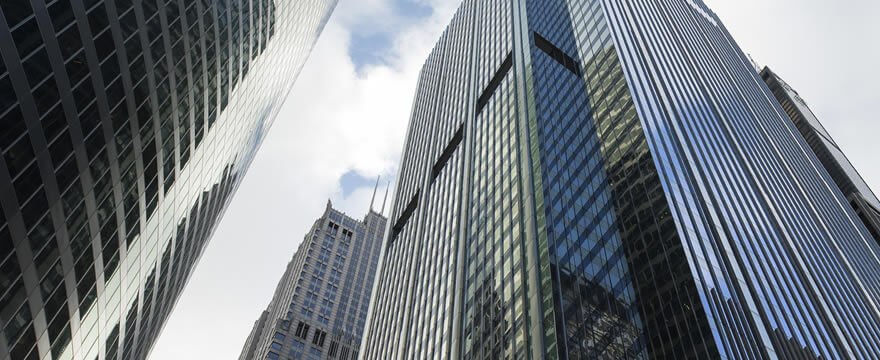 Color photo looking up between two skyscrapers in Chicago